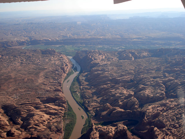 The Gateway rock formation shows ocludes the city of Moab, UT which is nestled within the valley. That's the mighty Colorado River in the foreground